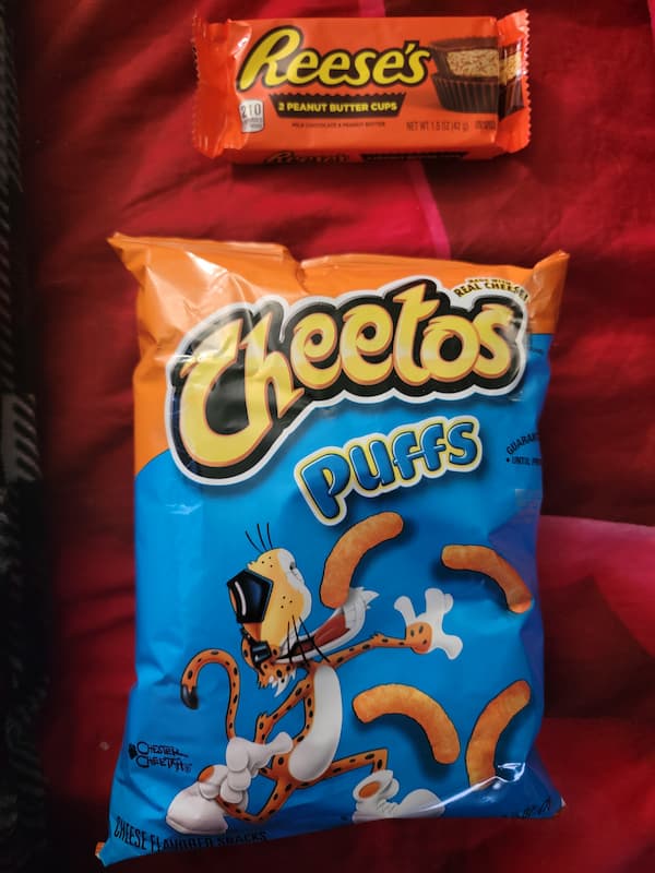 Prize of orange candy and orange cheese puffs.